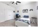 Bedroom features white walls, a bed, desk and a ceiling fan at 4033 Union Ln, North Port, FL 34288