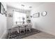 Bright dining room featuring a modern chandelier, a neutral color scheme and decorative artwork at 4033 Union Ln, North Port, FL 34288
