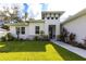 Inviting front entrance featuring a well landscaped yard and modern architectural design at 4033 Union Ln, North Port, FL 34288