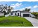 Beautiful single-story home with a well-maintained lawn and complemented by lush trees at 4033 Union Ln, North Port, FL 34288