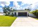 Charming single-story home showcasing a well-manicured lawn, spacious driveway and a two car garage at 4033 Union Ln, North Port, FL 34288