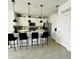 Bright kitchen with pantry, stainless steel appliances, and a spacious quartz island with seating at 4033 Union Ln, North Port, FL 34288