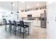 Contemporary kitchen featuring quartz island with bar stool seating, stainless steel appliances, and sleek cabinets at 4033 Union Ln, North Port, FL 34288