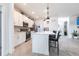 Modern kitchen with quartz island, pendant lighting, stainless steel appliances, and lots of cabinet space at 4033 Union Ln, North Port, FL 34288