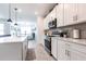 The kitchen features sleek white cabinets, stainless steel appliances, and a view to the dining area at 4033 Union Ln, North Port, FL 34288