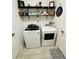 Laundry room featuring front load washer and dryer, and shelving decor at 4033 Union Ln, North Port, FL 34288