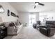 Comfortable living room with sliding door to backyard, neutral colors and wood-look floors at 4033 Union Ln, North Port, FL 34288