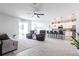 Bright open-concept living room flowing into kitchen, and featuring wood-look floors at 4033 Union Ln, North Port, FL 34288