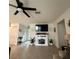 Spacious living room with stylish fireplace, ceiling fan and wood-look tile flooring at 4033 Union Ln, North Port, FL 34288