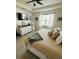 Cozy main bedroom featuring a large window, modern decor, and tile flooring at 4033 Union Ln, North Port, FL 34288