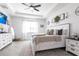 Comfortable main bedroom featuring a large bed, a modern ceiling fan, and a stylish dresser at 4033 Union Ln, North Port, FL 34288