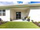 Enjoy this home's covered patio, featuring seating, decor, and artificial turf at 4033 Union Ln, North Port, FL 34288