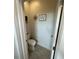 Small half-bathroom features neutral paint, decorative accents, and toilet at 4033 Union Ln, North Port, FL 34288
