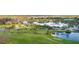 An aerial view of the golf course and clubhouse featuring manicured lawns and lush landscaping at 408 Cerromar S Cir # 331, Venice, FL 34293