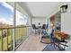 Spacious balcony with seating, offering a peaceful view of the landscape and distant buildings at 408 Cerromar S Cir # 331, Venice, FL 34293