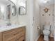 Bright bathroom features a wood vanity, modern fixtures, toilet and seaside turtle decorations at 408 Cerromar S Cir # 331, Venice, FL 34293