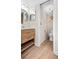 Bright bathroom features a wood vanity, modern fixtures, toilet and seaside turtle decorations at 408 Cerromar S Cir # 331, Venice, FL 34293