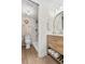 Bright bathroom features a wood vanity, modern fixtures, toilet and marble tiled shower at 408 Cerromar S Cir # 331, Venice, FL 34293