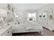 Comfortable bedroom with light-colored furniture and decor that allows access to the outside covered patio at 408 Cerromar S Cir # 331, Venice, FL 34293