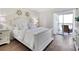 Bright bedroom with stylish decor, a plush bed, and access to a private balcony overlooking scenic views at 408 Cerromar S Cir # 331, Venice, FL 34293