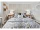 Comfortable bedroom featuring decorative bedside tables and patterned bedding at 408 Cerromar S Cir # 331, Venice, FL 34293