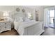 Bright bedroom with stylish decor, a plush bed, and access to a private balcony overlooking scenic views at 408 Cerromar S Cir # 331, Venice, FL 34293