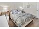 Bedroom features a nicely made bed, wooden floors, and a built-in desk with chair at 408 Cerromar S Cir # 331, Venice, FL 34293