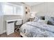 Bright bedroom featuring a white desk, decorative shelves, and patterned bedding at 408 Cerromar S Cir # 331, Venice, FL 34293