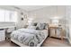 Bedroom features a nicely made bed, wooden floors, and a built-in desk with chair at 408 Cerromar S Cir # 331, Venice, FL 34293