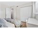 Bedroom featuring a nicely made bed, wooden floors, and a built-in desk with chair at 408 Cerromar S Cir # 331, Venice, FL 34293