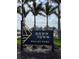 Wellen Park community sign featuring manicured landscaping and palm tree lined street at 408 Cerromar S Cir # 331, Venice, FL 34293
