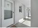 Hallway leading to condos with white exterior walls and tiled floors at 408 Cerromar S Cir # 331, Venice, FL 34293