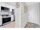 Hallway adjacent to kitchen features white door and stainless steel refrigerator at 408 Cerromar S Cir # 331, Venice, FL 34293