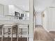 Hallway view into kitchen with white bar stools at 408 Cerromar S Cir # 331, Venice, FL 34293