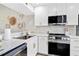 A kitchen featuring stainless steel appliances, light countertops, and white cabinets at 408 Cerromar S Cir # 331, Venice, FL 34293