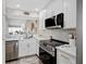 Updated kitchen with stainless steel appliances and white cabinets at 408 Cerromar S Cir # 331, Venice, FL 34293