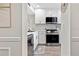 Modern kitchen view through doorway featuring stainless appliances and white cabinetry at 408 Cerromar S Cir # 331, Venice, FL 34293