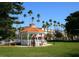 Charming white gazebo set in a lush green park with palm trees and buildings in the background at 408 Cerromar S Cir # 331, Venice, FL 34293