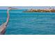 Scenic waterfront featuring a great blue heron and distant figures on a rocky pier at 408 Cerromar S Cir # 331, Venice, FL 34293