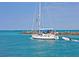 Beautiful sailboat approaching a pier with clear blue water on a sunny day at 408 Cerromar S Cir # 331, Venice, FL 34293