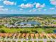 Aerial view of a residential community surrounding a scenic lake and a beautiful golf course at 4114 Murfield E Dr, Bradenton, FL 34203