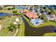 Aerial view showcasing community amenities: clubhouse, swimming pool, golf course, tennis courts and walking bridge at 4114 Murfield E Dr, Bradenton, FL 34203