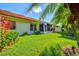 A beautiful backyard features a screened lanai, vibrant landscaping, and a well-maintained lawn at 4114 Murfield E Dr, Bradenton, FL 34203