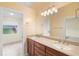 Bathroom featuring double sinks, granite countertops, large mirror, and decorative lighting at 4114 Murfield E Dr, Bradenton, FL 34203