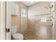 Bright bathroom with tiled shower, glass door, and convenient grab bar for added safety and accessibility at 4114 Murfield E Dr, Bradenton, FL 34203