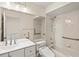 Well-maintained bathroom featuring grab bars, a shower-tub combination, and a modern, efficient toilet at 4114 Murfield E Dr, Bradenton, FL 34203