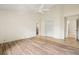 Spacious bedroom with tile flooring, ceiling fan, and walk-in closet at 4114 Murfield E Dr, Bradenton, FL 34203