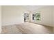 Bright bedroom featuring wood tile floors, sliding glass door, and large window with a view at 4114 Murfield E Dr, Bradenton, FL 34203