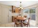 Bright breakfast area featuring a wooden table, a sliding glass door, and tiled floors at 4114 Murfield E Dr, Bradenton, FL 34203