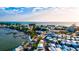 Aerial view of waterfront community featuring charming homes, shops, restaurants, bay access, and beach nearby at 4114 Murfield E Dr, Bradenton, FL 34203